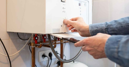 Man lowers the temperature of the gas boiler